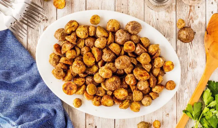 https://www.littlepotatoes.com/recipes/extra-crispy-roasted-little-potatoes/ A platter extra crispy roasted potatoes.