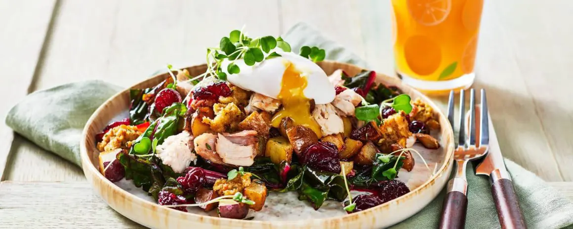 Festive holiday brunch spread featuring Little Potatoes, eggs, and breakfast sides arranged on a table with seasonal decor.