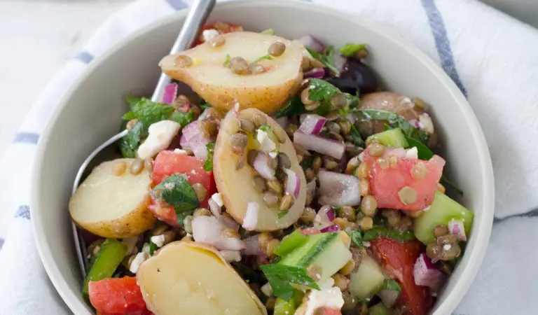A bowl of Greek salad and lentils.