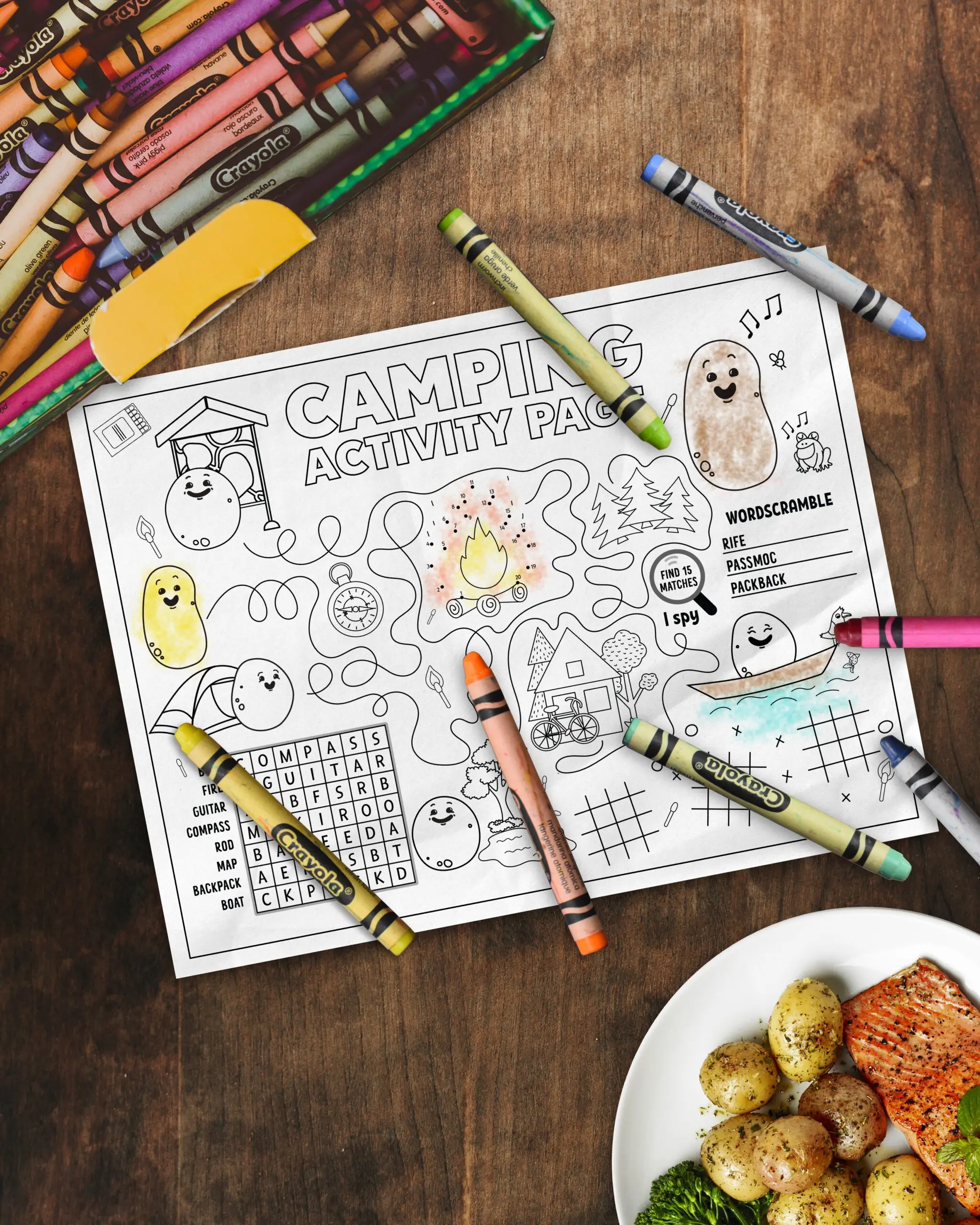 A camping themed coloring page on a table with crayons.