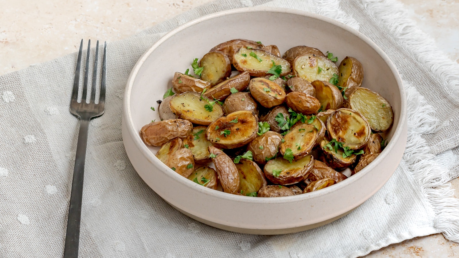 A bowl of garlic and parsley-topped Little Reds™.