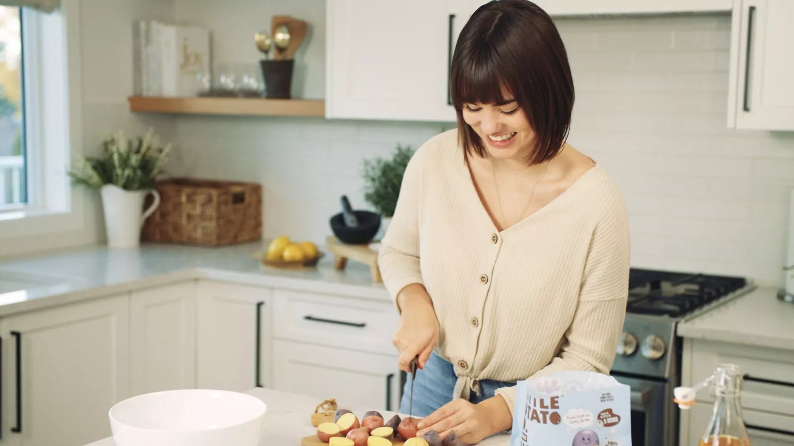 Time Saving Tips for Entertaining Feature Image_1600x900 A woman in the kitchen chopping up some Little Potatoes.