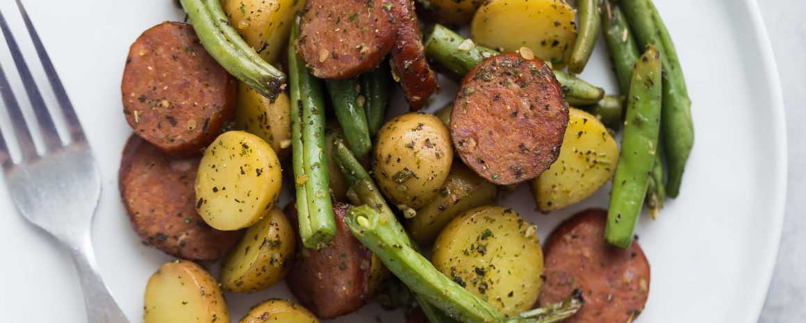 One pan sausage potatoes and green beans on a plate.