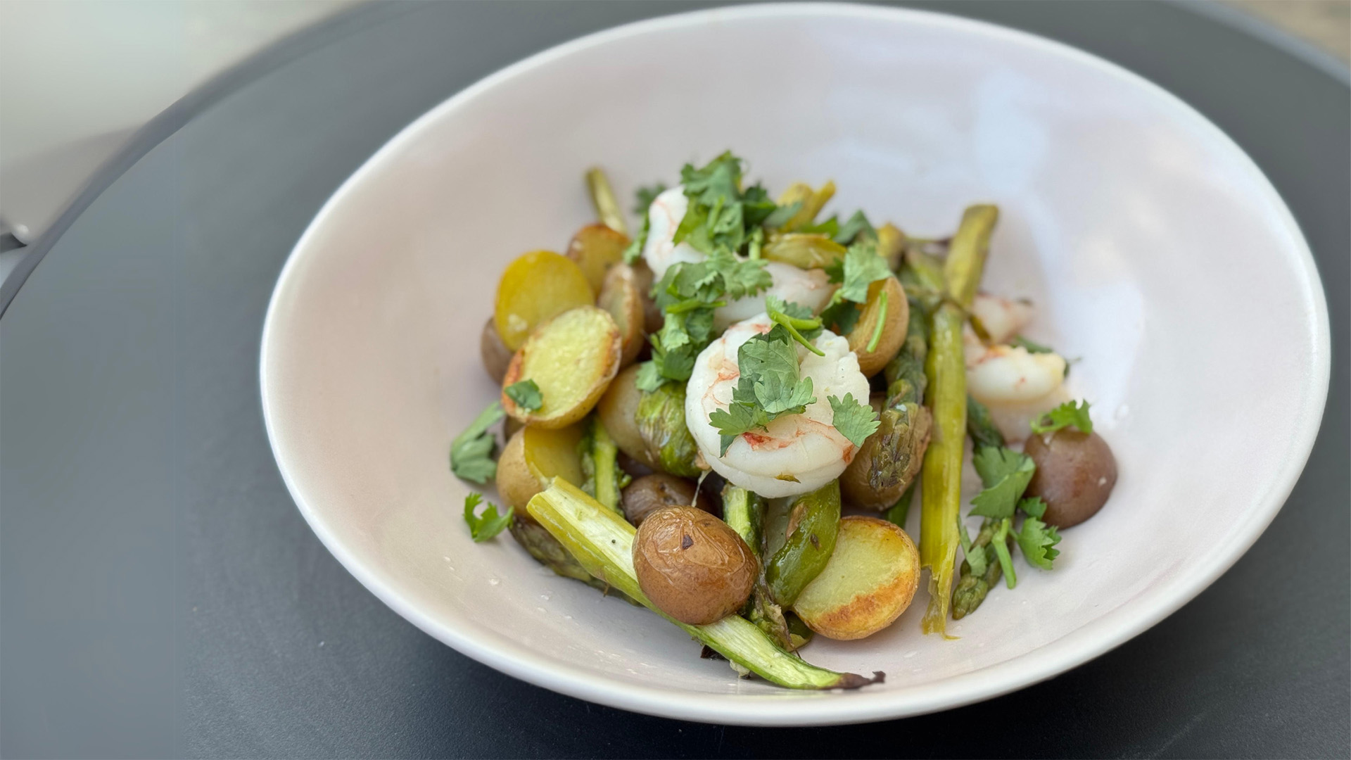 A bowl of shrimp, asparagus, and Little Potatoes.