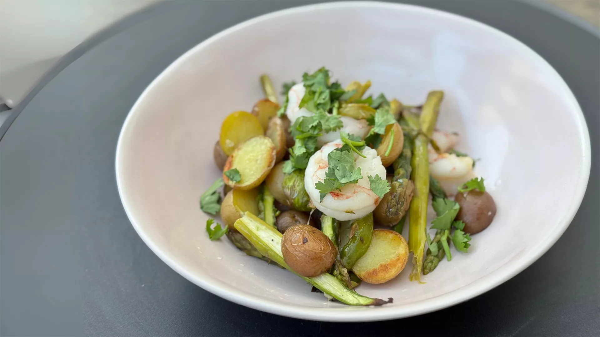 Sheet Pan Shrimp and Little Potatoes A bowl of shrimp, asparagus, and Little Potatoes.