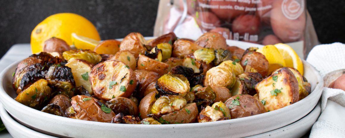 A bowl of lemony roasted Brussels sprouts with Little Potatoes.