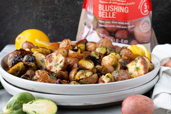 A bowl of lemony roasted Brussels sprouts with Little Potatoes.
