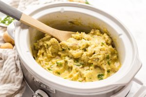 A slow cooker full of delicious mashed potatoes.