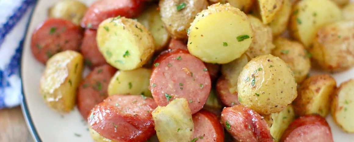 A delicious Air Fryer meal with sausages and little potatoes.