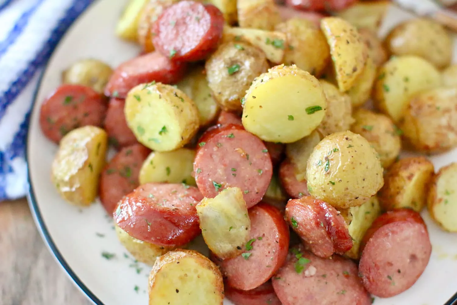 A delicious Air Fryer meal with sausages and little potatoes.