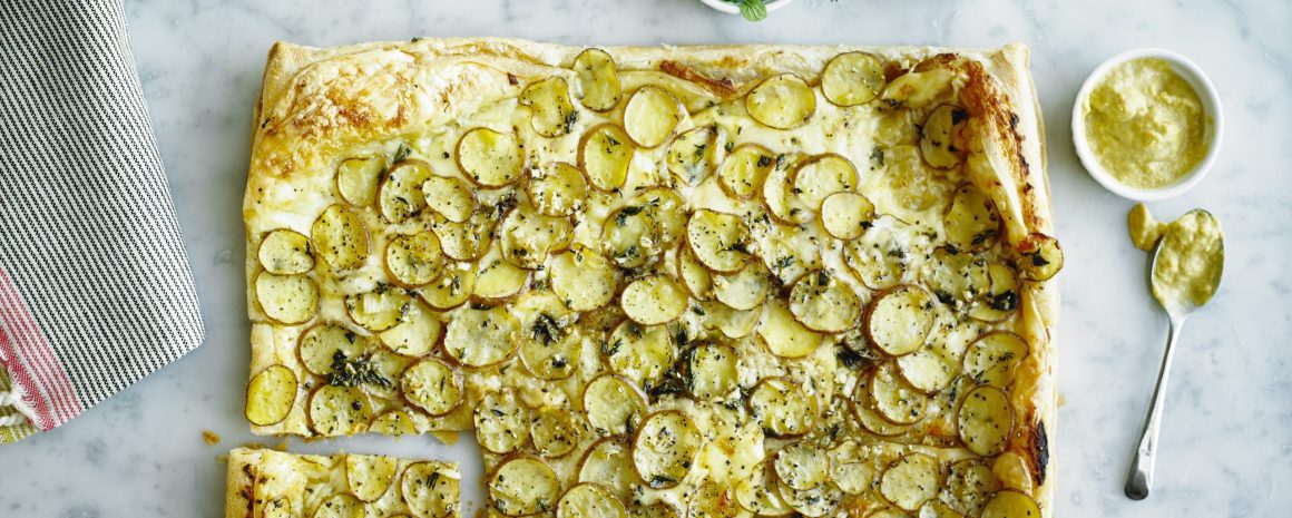 A cheese tart with little potatoes.