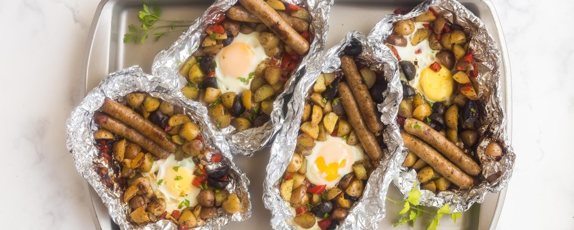 A baking sheet of the most delicious camping breakfast you could ever hope to have. Sausages, potatoes, peppers. Yum.