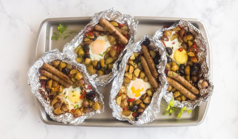 A baking sheet of the most delicious camping breakfast you could ever hope to have. Sausages, potatoes, peppers. Yum.