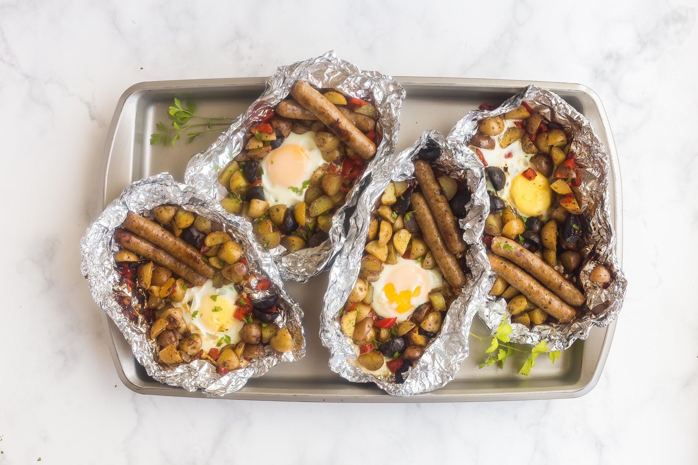 A baking sheet of the most delicious camping breakfast you could ever hope to have. Sausages, potatoes, peppers. Yum.