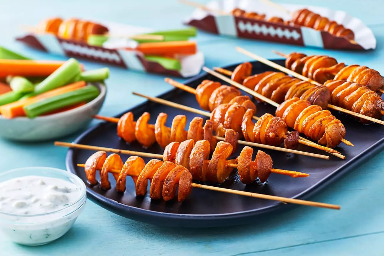 Game day recipes! Corkscrew potatoes on a wooden skewer.