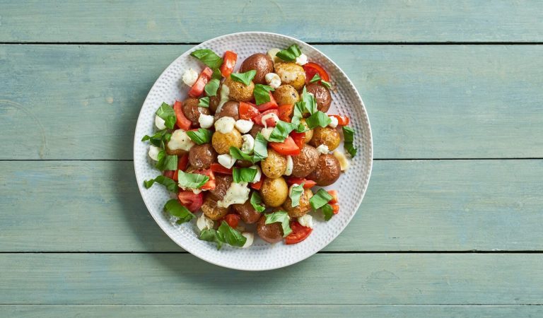 A beautiful colorful bowl of caprese roasted little potatoes.