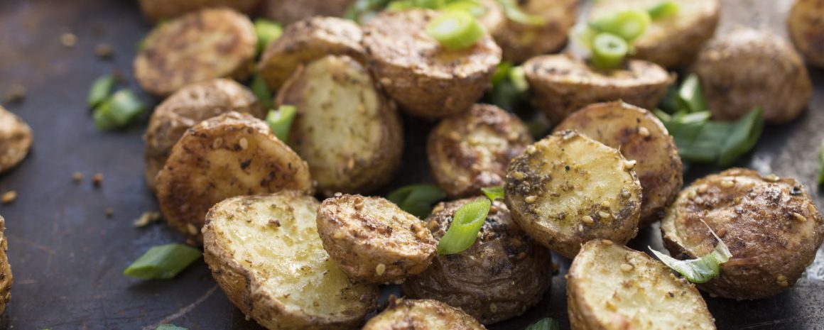 A plate of roasted little potatoes with za'atar spices.