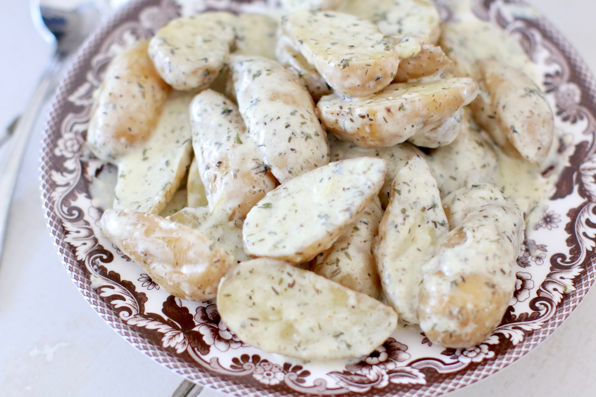 Fingerling potatoes covered in a creamy sauce.