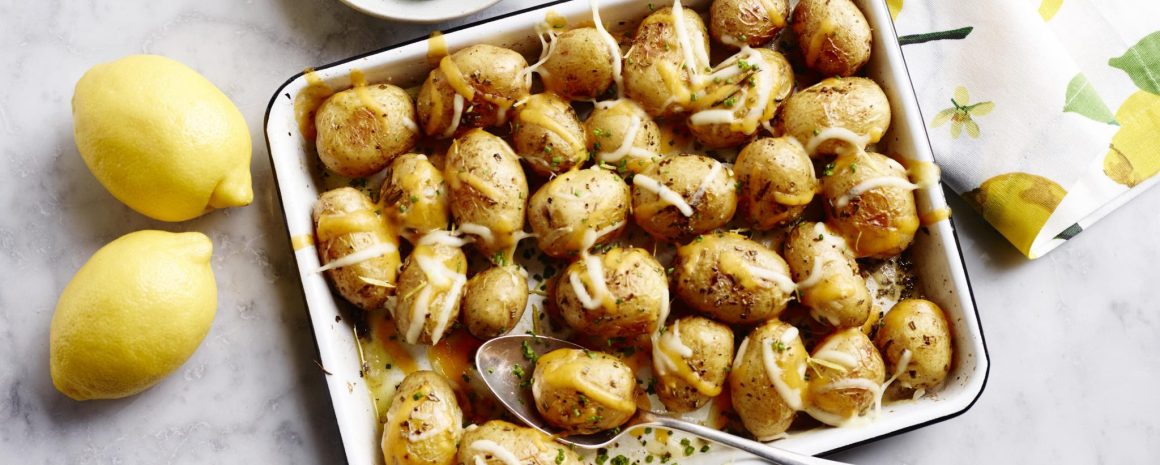 A roasting tray of cheesy little potatoes.
