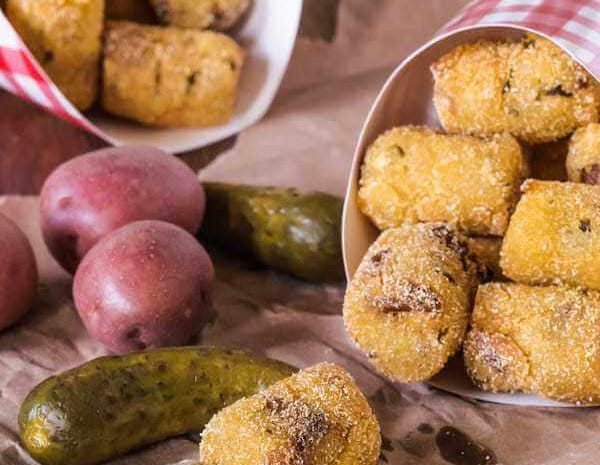 Fried potato pickle pops in take out containers.