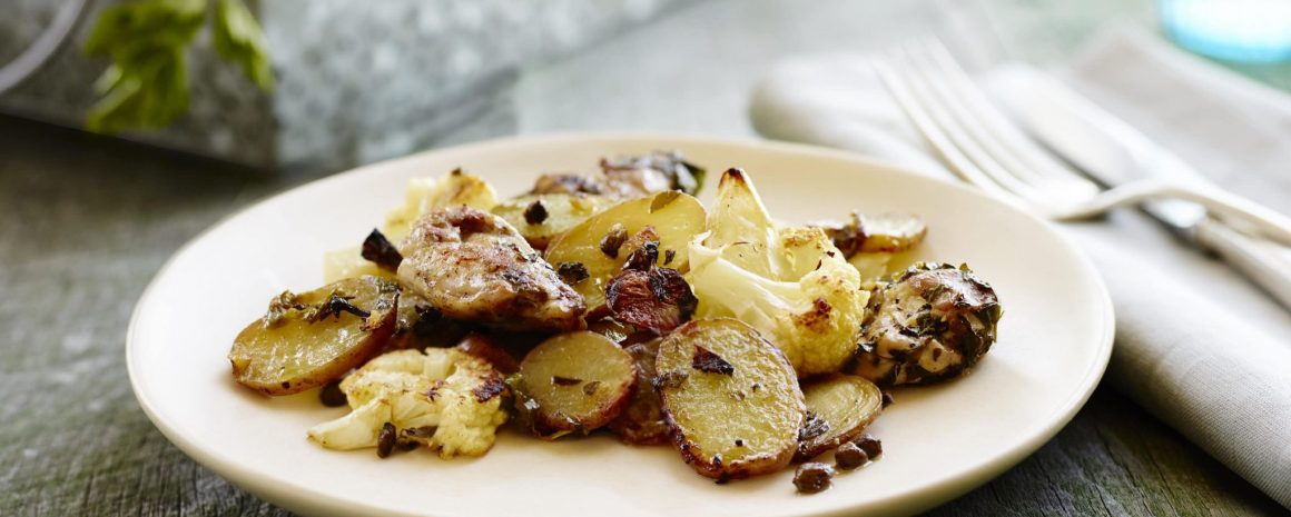 A plate of chicken potatoes and cauliflower.