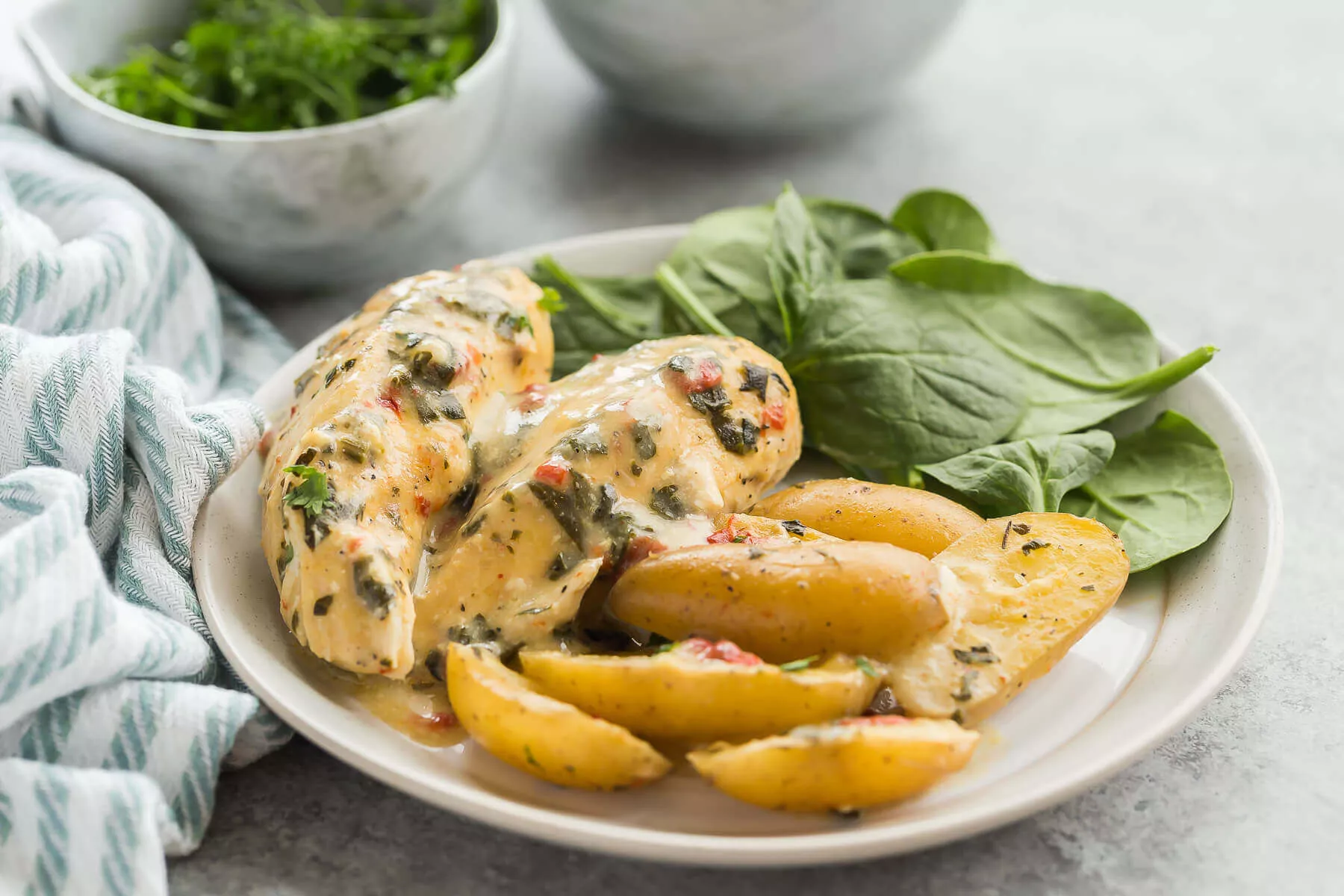 Italian slow cooker chicken and potatoes on a plate.