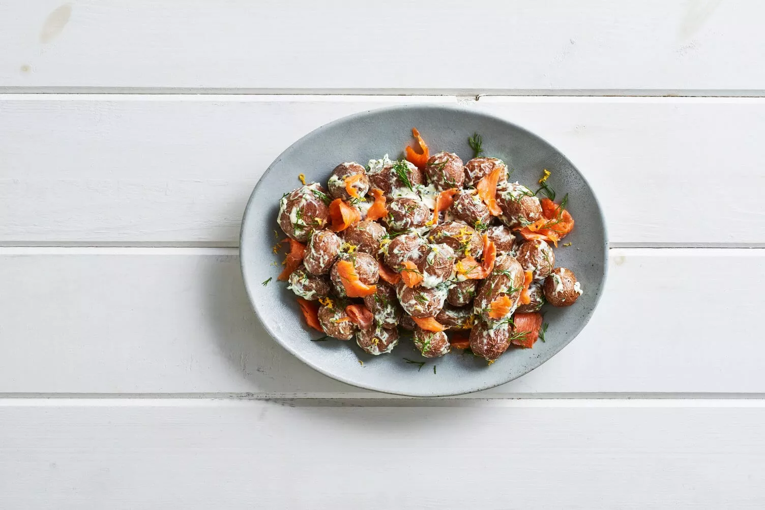 Smoked salmon lox roasted potatoes in a nice little platter.