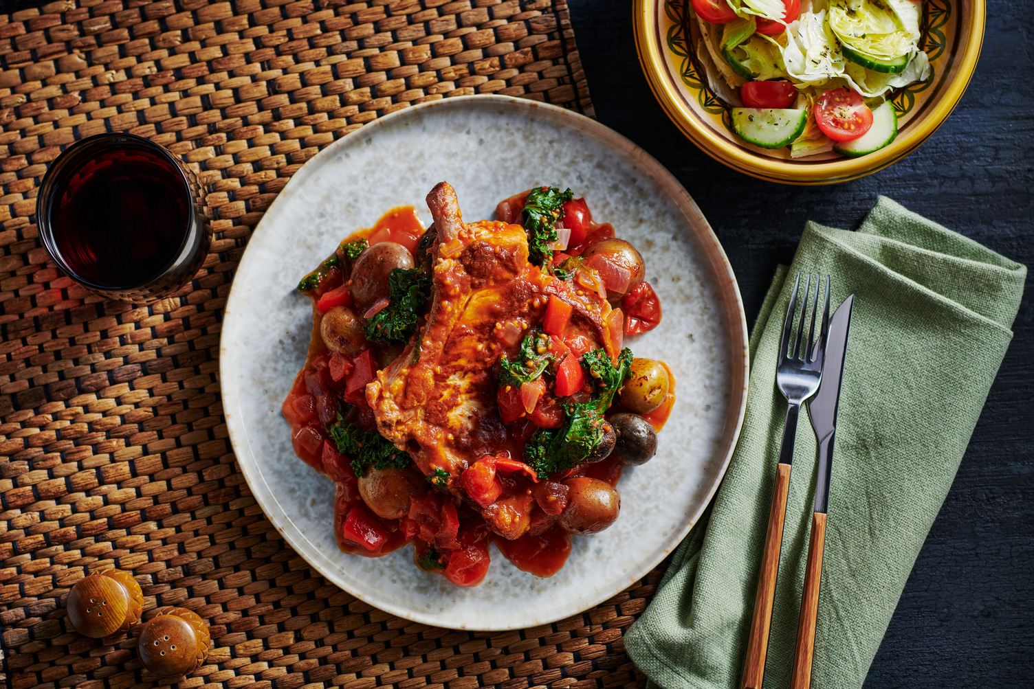 Pork chops and potatoes in at tomato pepper sauce.