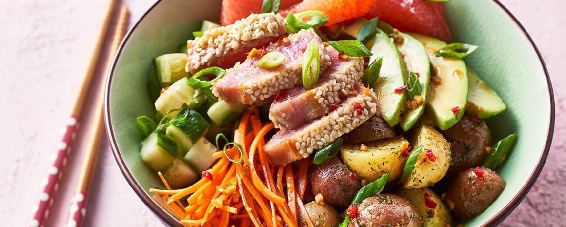 A poke bowl made with potatoes and tuna with avocado and other delicious fresh veggies.