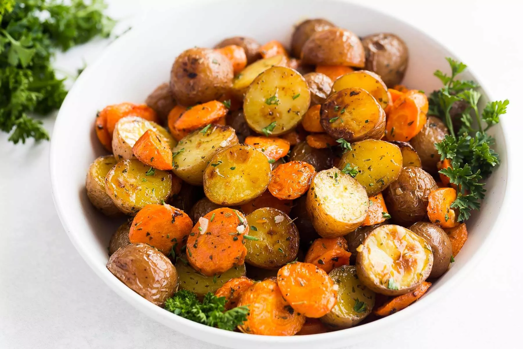 A bowl of roasted potatoes and carrots.