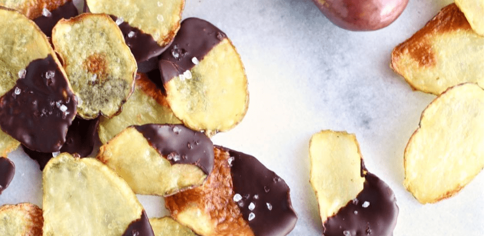 A plate of delicious potato chips dipped in dark chocolate.