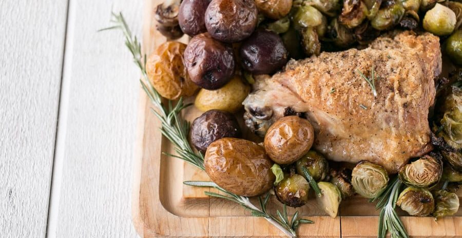 A platter of sheet pan turkey and potatoes.