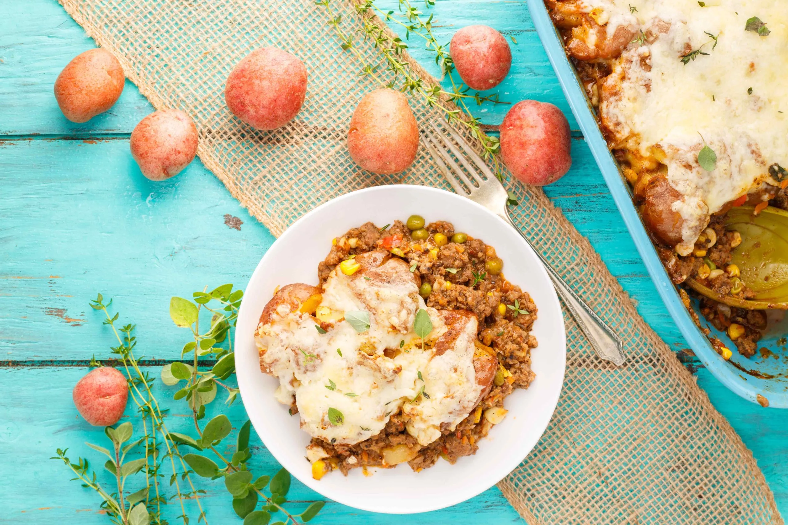 Smashed potato shepherd's pie in a serving dish and on a plate.