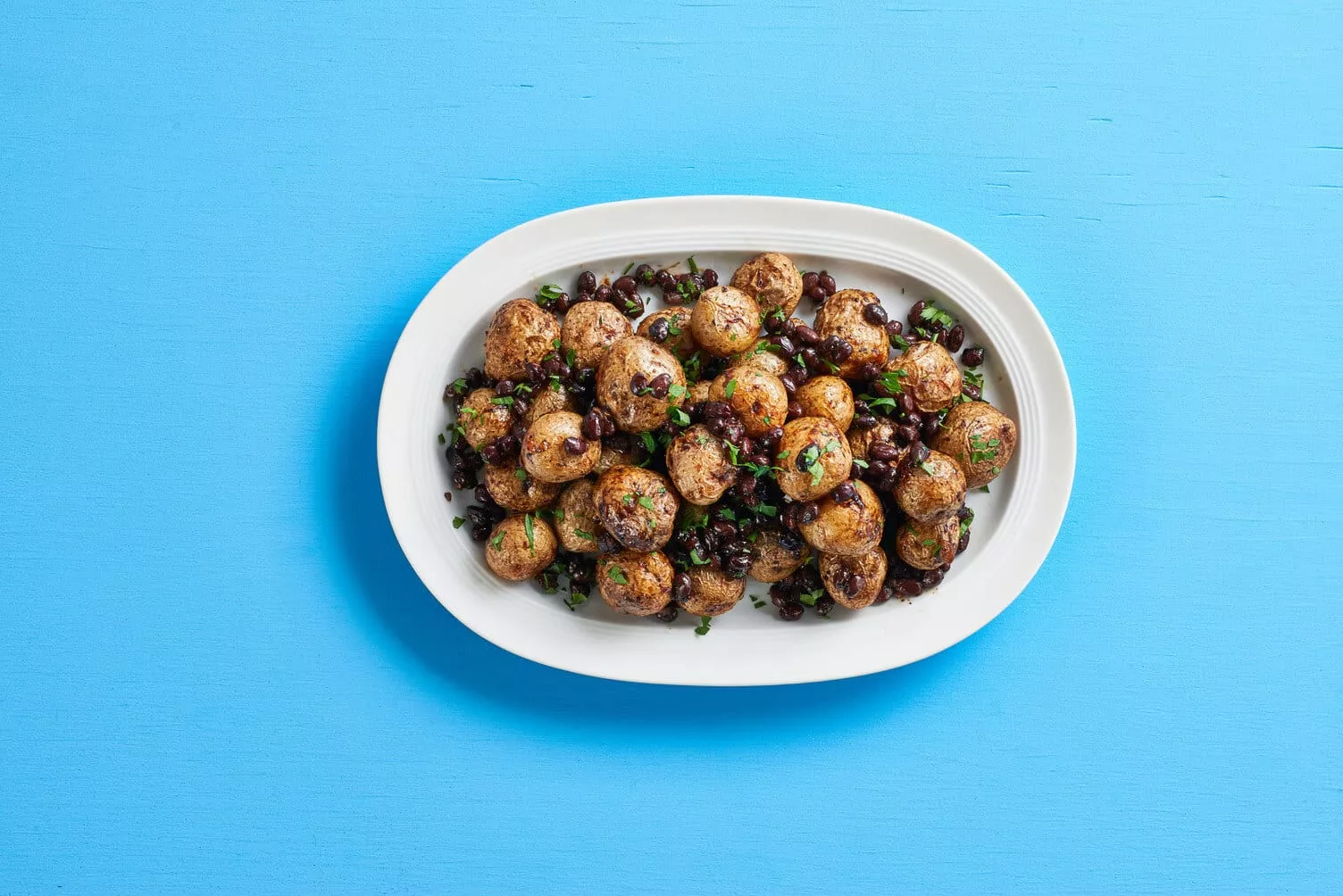 A plate of spicy black bean roasted potatoes