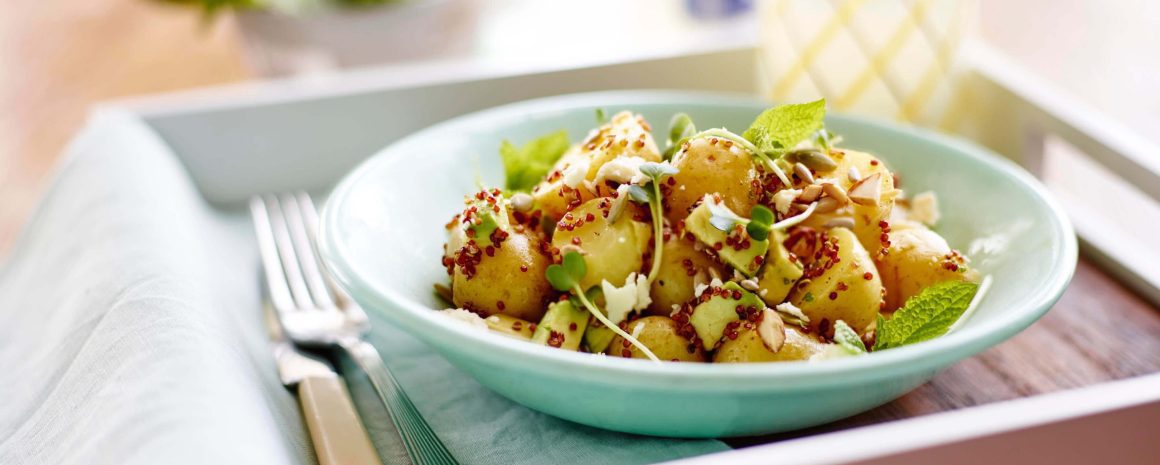 A bowl of Little Potatoes, microgreens, and feta.