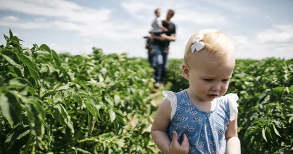 Sustainability_On the Farm_580x305 A cute child in a field of potato plants.
