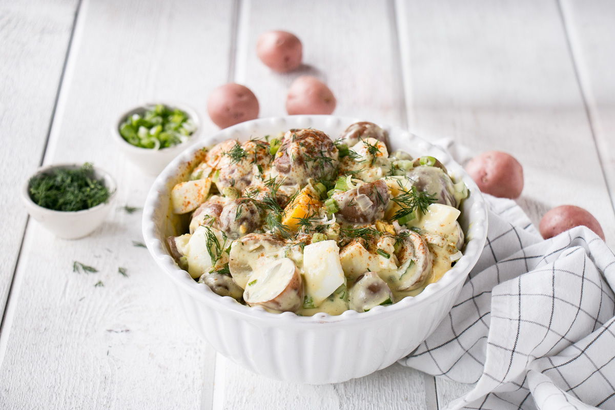 A delicious bowl of potato salad with all the fixings.