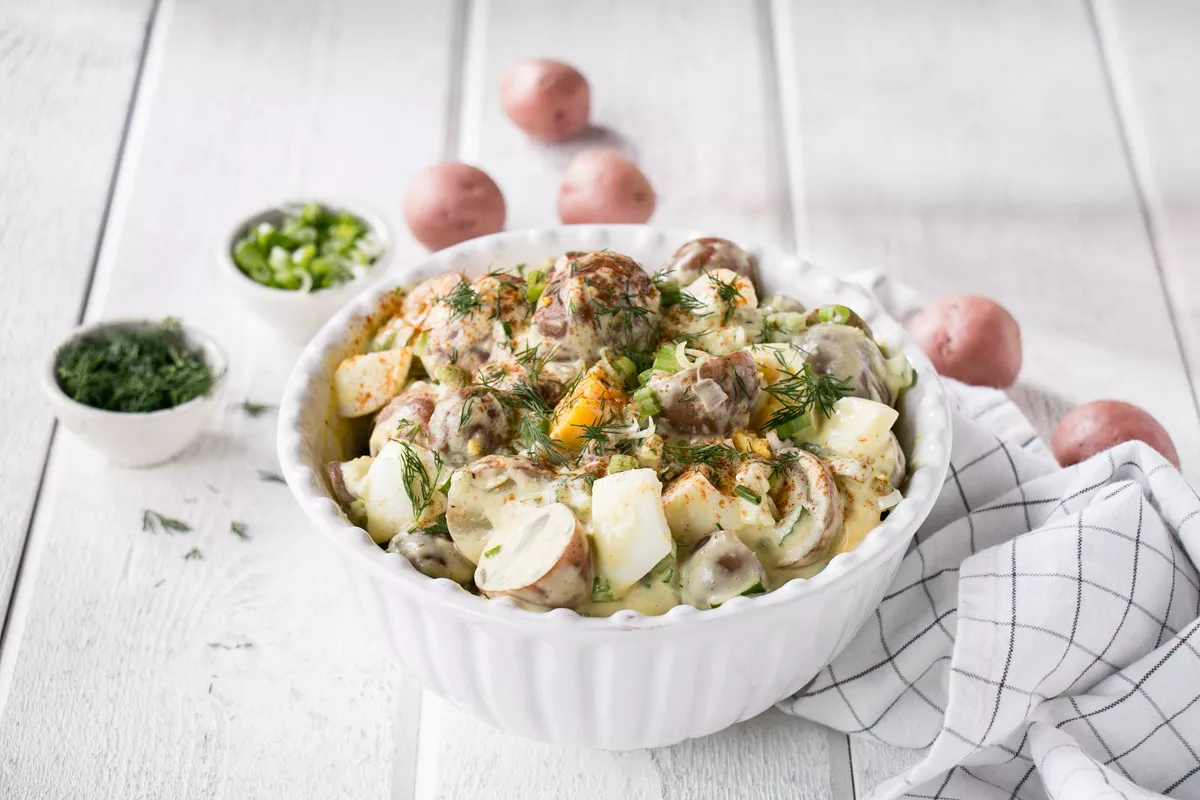 A delicious bowl of potato salad with all the fixings.