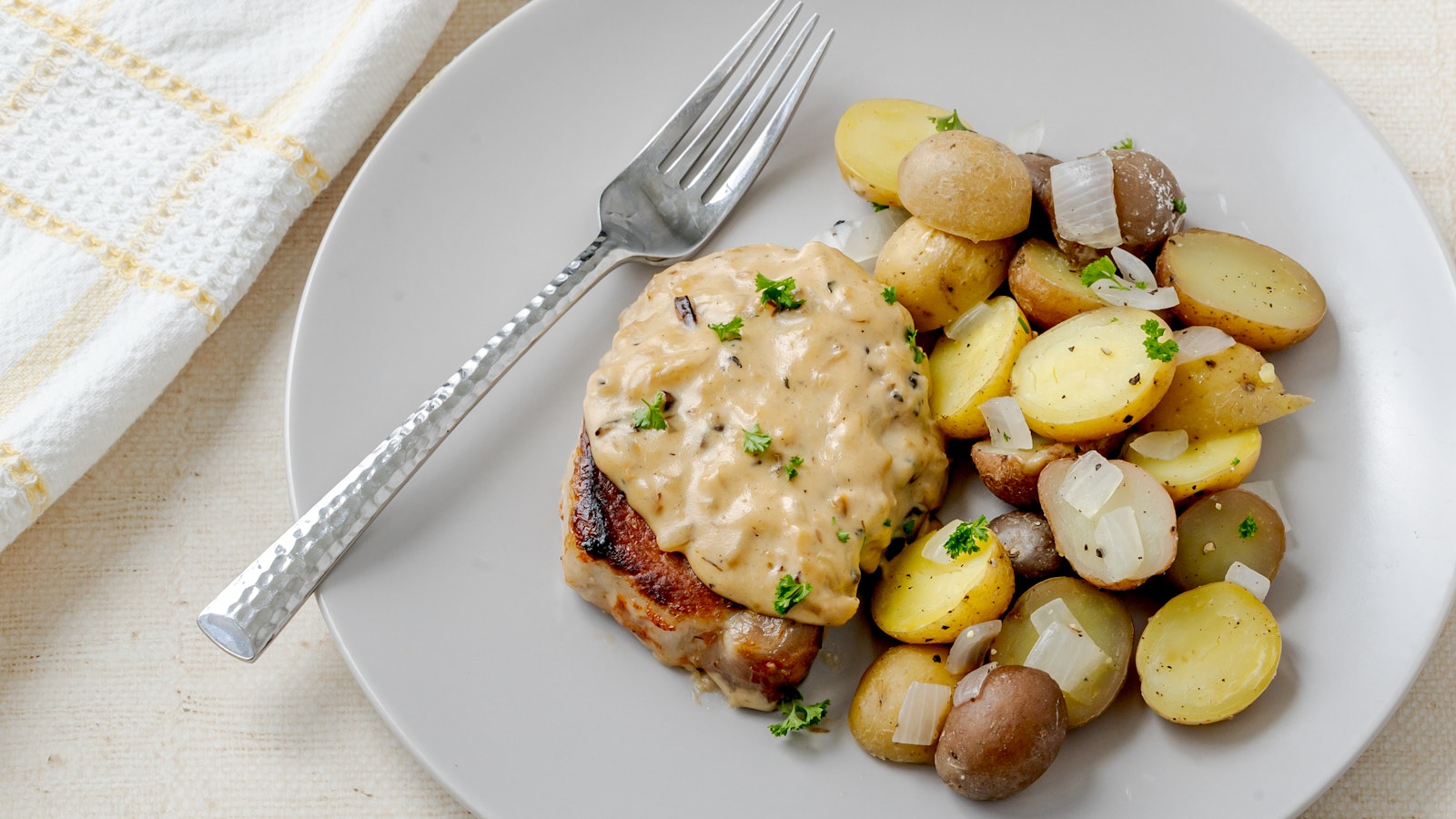 A plate of pork chops and Little Duos™ smothered in delicious gravy.