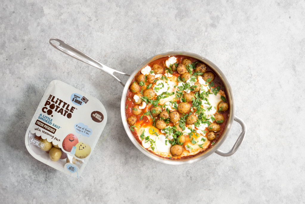 A pot with a homemade shakshuka with tomatoes and Little Potatoes and other yummy veggies.