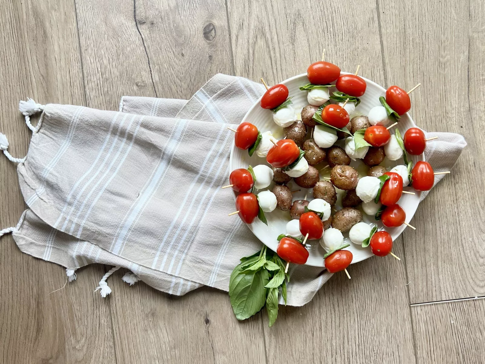 Caprese potato skewers on a plate.