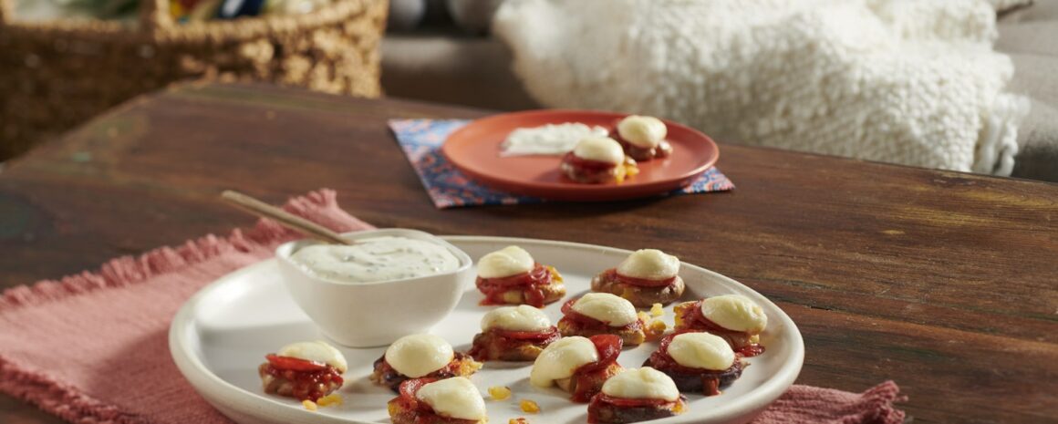 A plate of mini potato pizza bites.