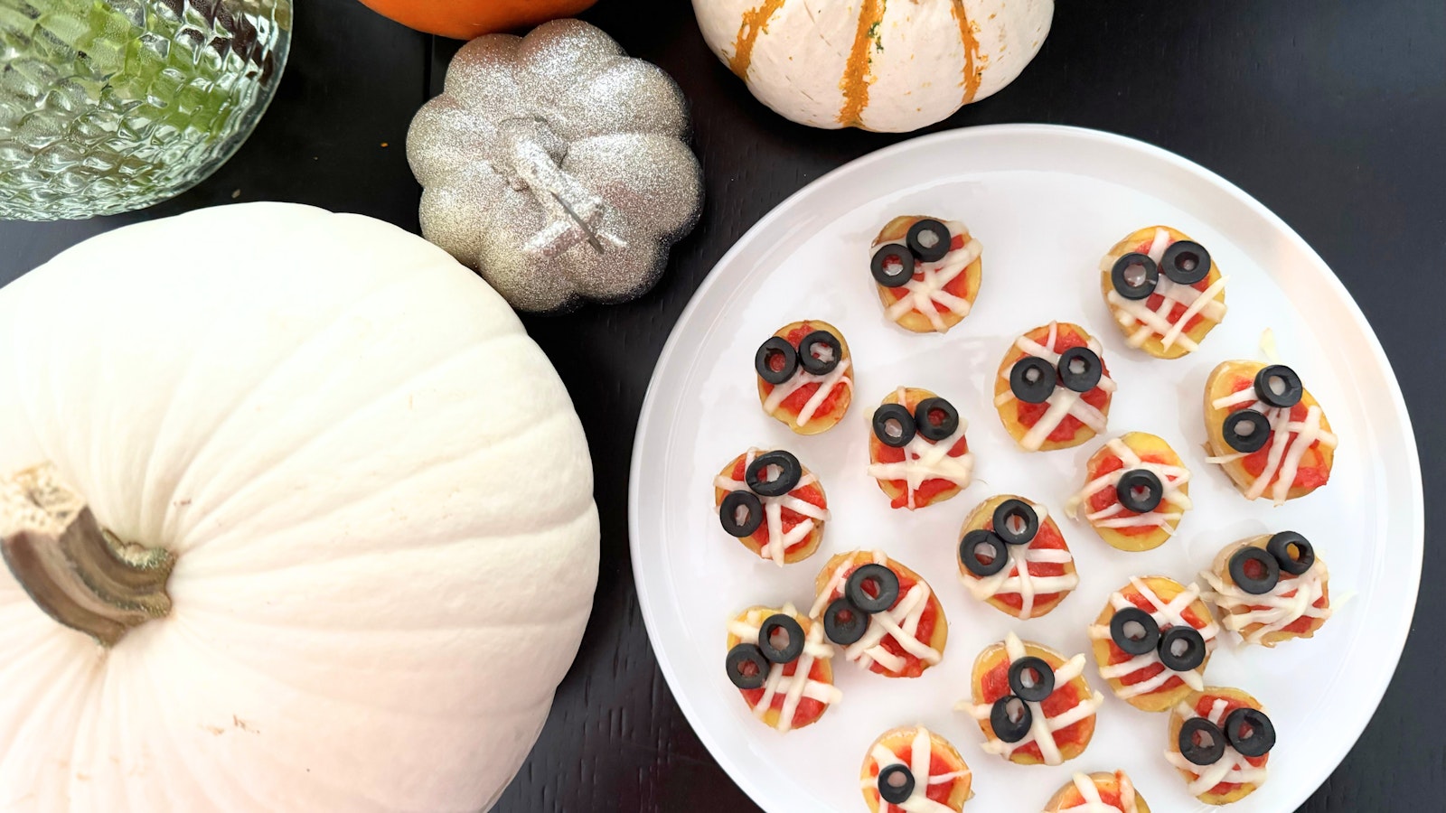 A plate of halved Little Potatoes made to look like little mummy heads.