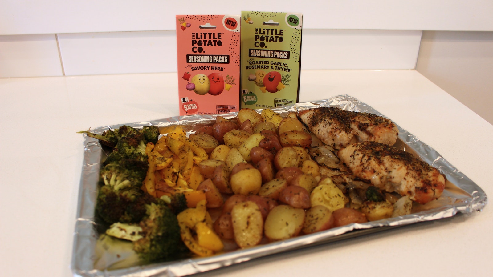 A sheet pan recipe of Little Potatoes, chicken, and veggies.