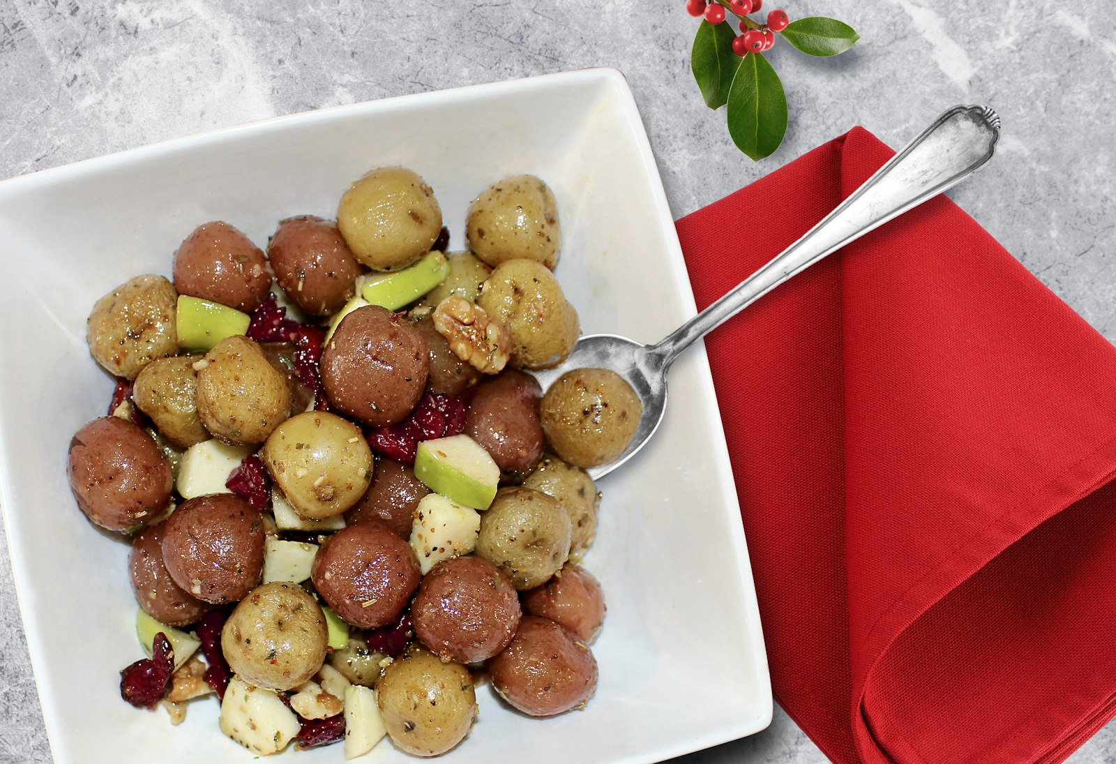 A warm cranberry and potato salad in a bowl.