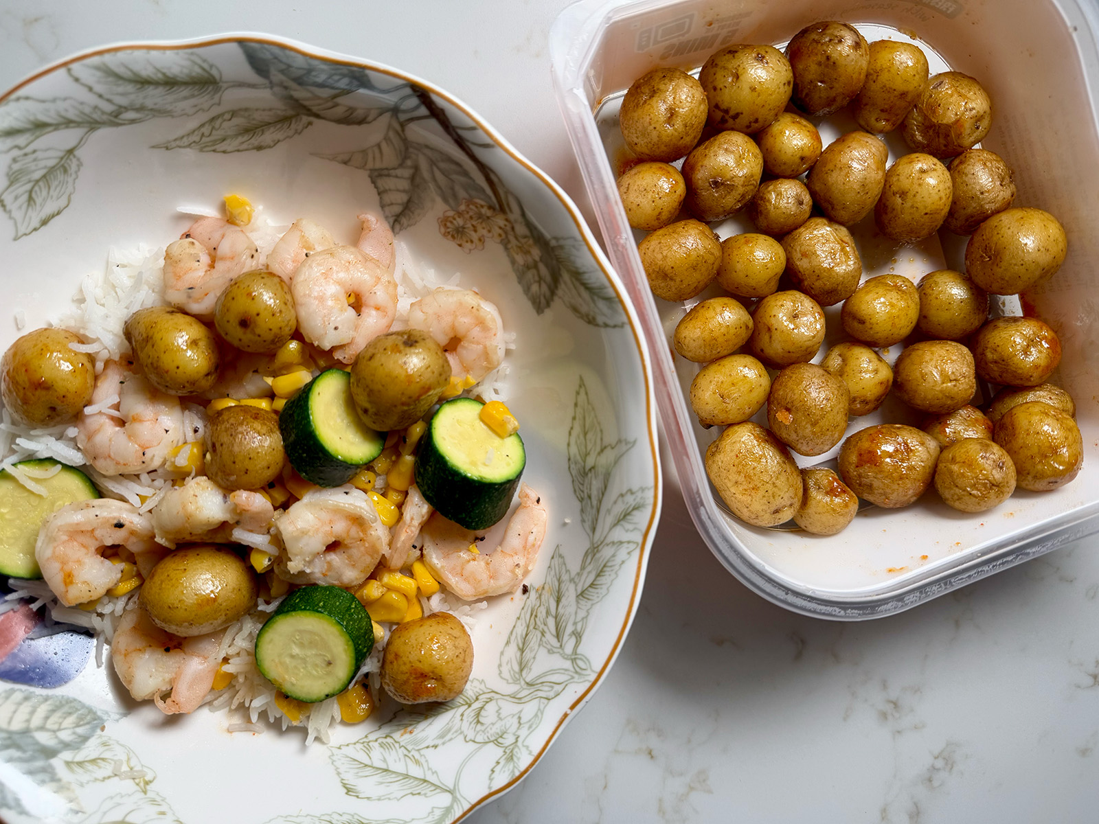 A burrito bowl featuring Little Potatoes, shrimp, and veggies on a bed of rice.