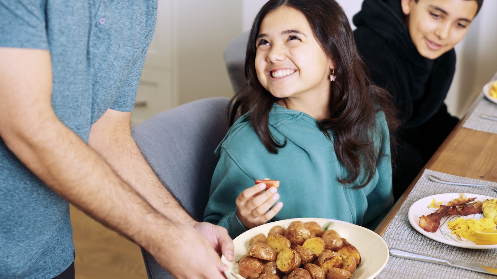 Family eating breakfast together at the table