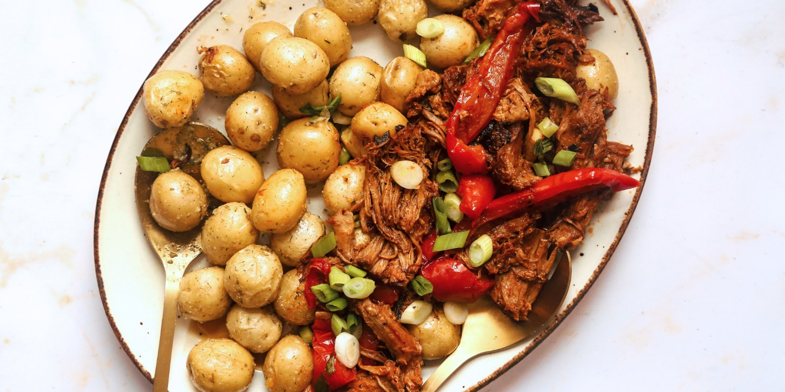 A plate of A Little Homestyle Ranch™ Microwave Little Potatoes with some slow cooked pork and other veggies.