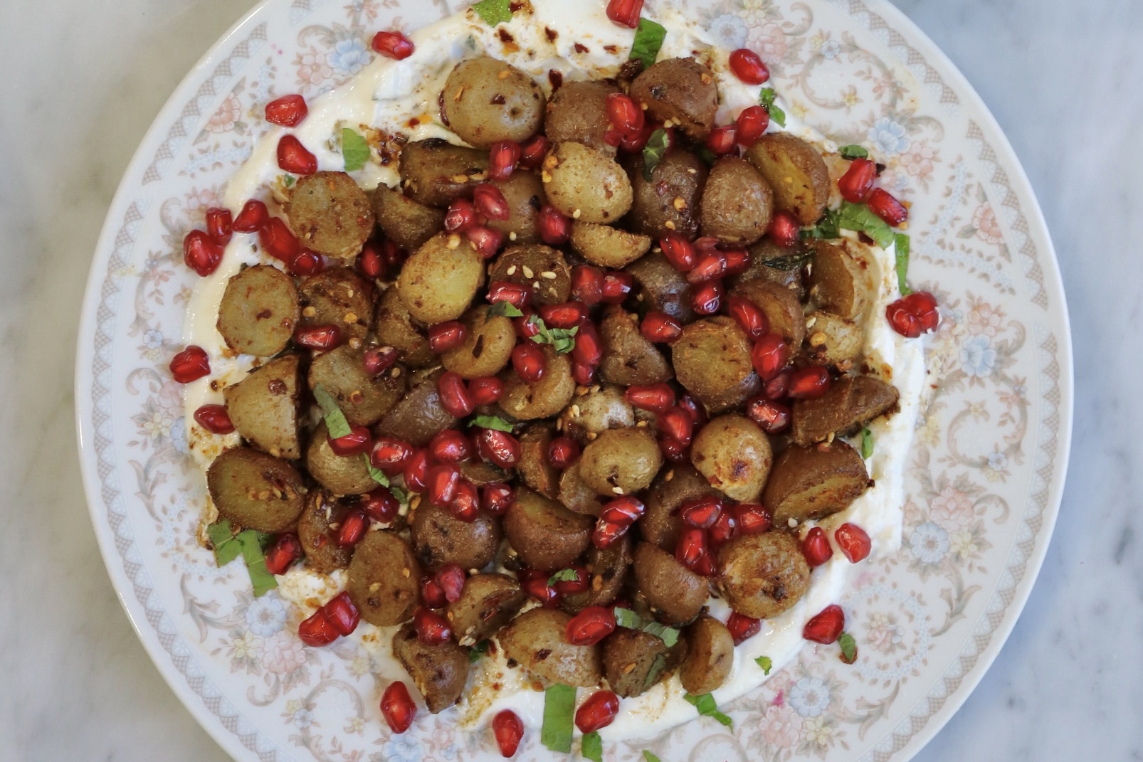 A white plate with some za'atar roasted Little Potatoes.